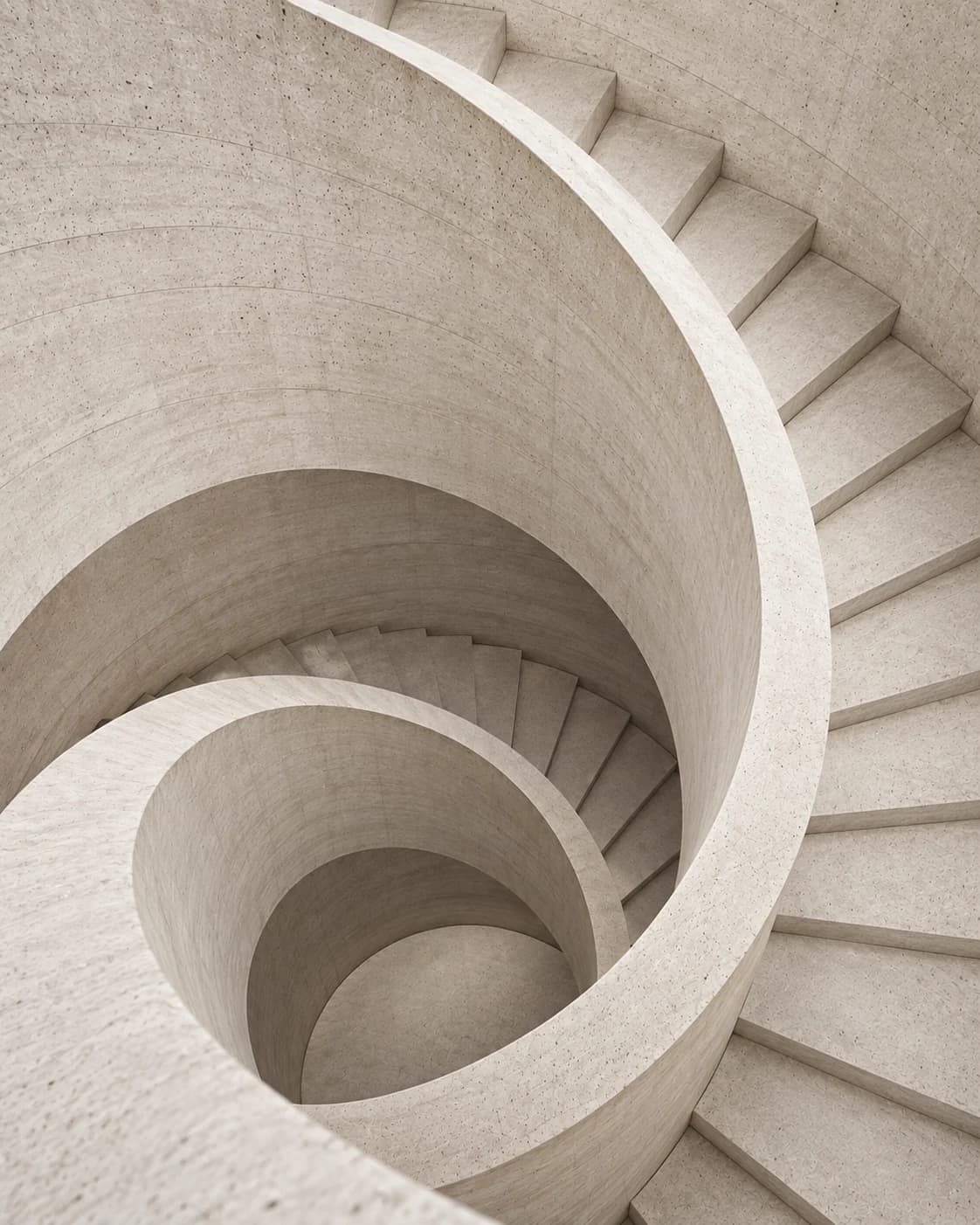 Abstract view looking down into a concrete spiral stair, its flights winding away.